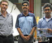 (L to R) Professor Ed Boj&#233;, Vinesh Maharaj and Yashren Reddi holding the two-wheeled inverted 
pendulum robot